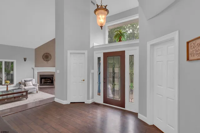 a view of a livingroom with wooden floor a fireplace and window
