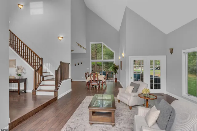 a living room with furniture and floor to ceiling windows