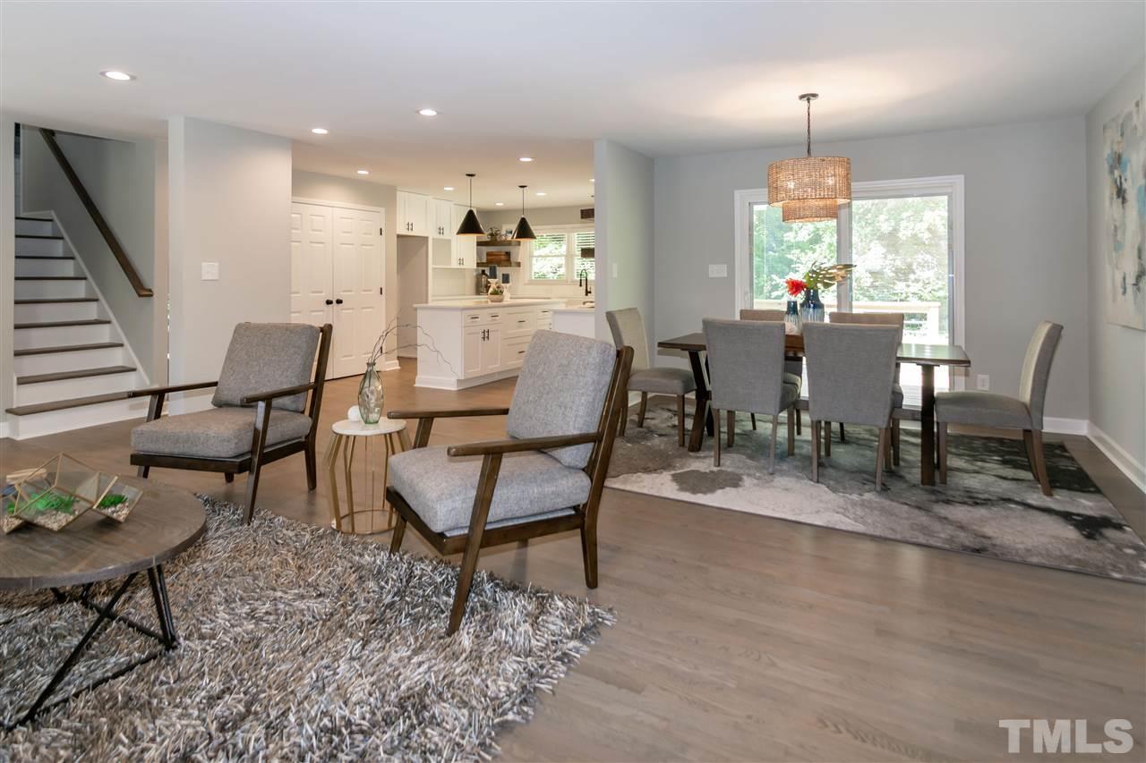 3804 Colgate Place Raleigh, NC 27609 - Photo 13 of 30 a dining room with wooden floor a glass table and chairs
