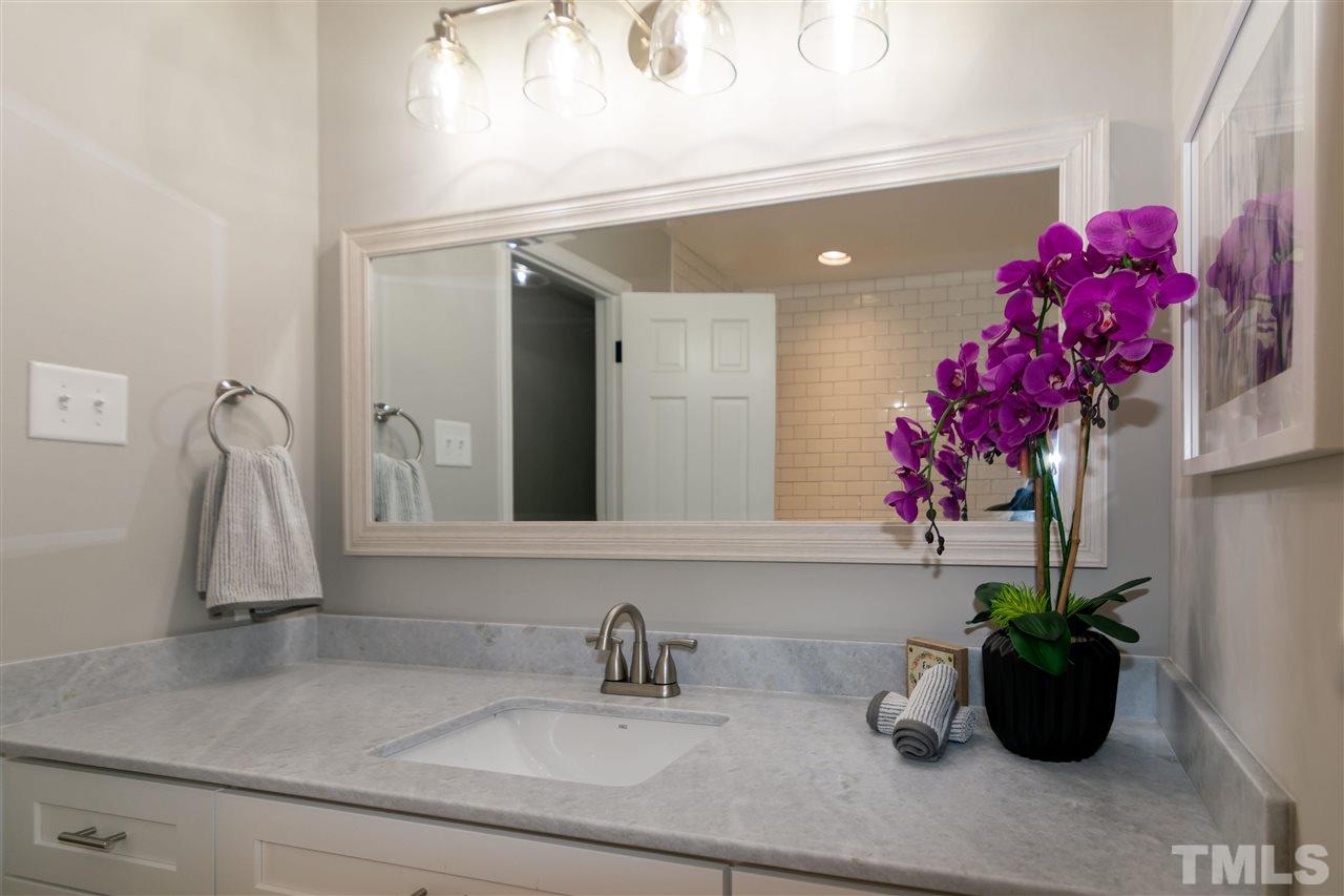 3804 Colgate Place Raleigh, NC 27609 - Photo 24 of 30 a bathroom sink with a granite countertop