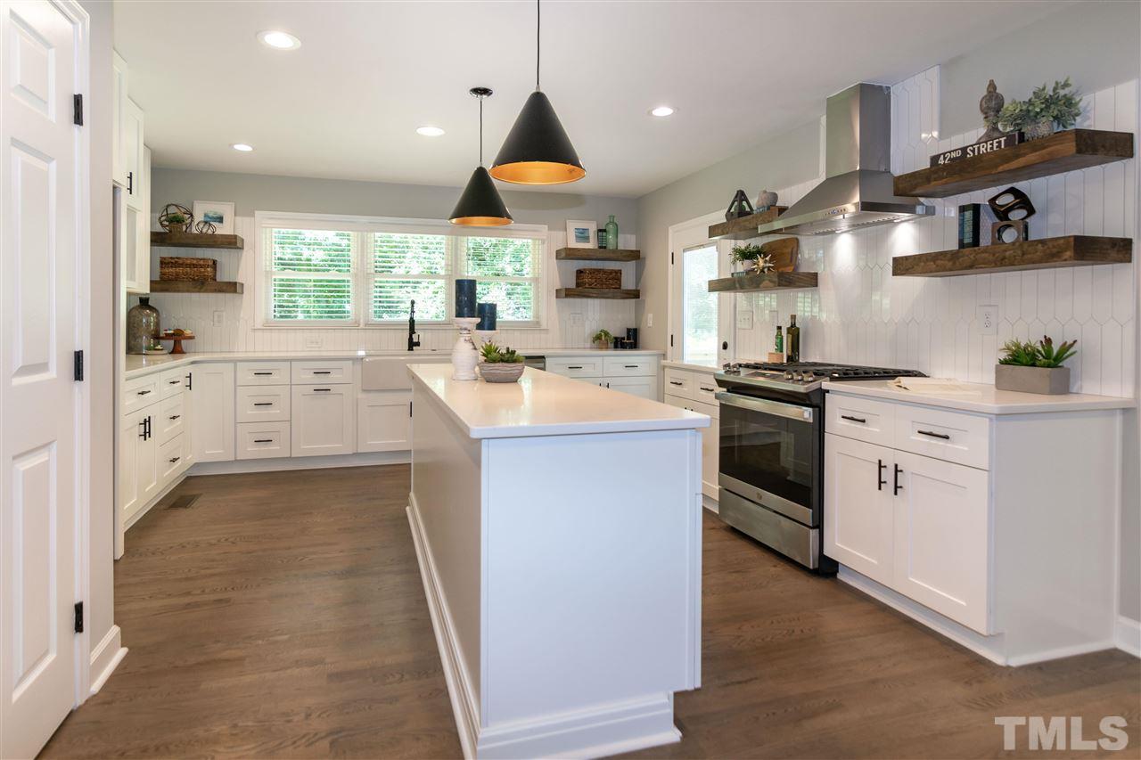 3804 Colgate Place Raleigh, NC 27609 - Photo 5 of 30 a kitchen with white cabinets stainless steel appliances and sink