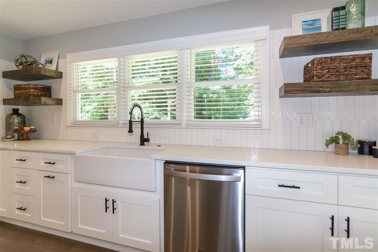 3804 Colgate Place Raleigh, NC 27609 - Photo 7 of 30 a kitchen with white cabinets and a window