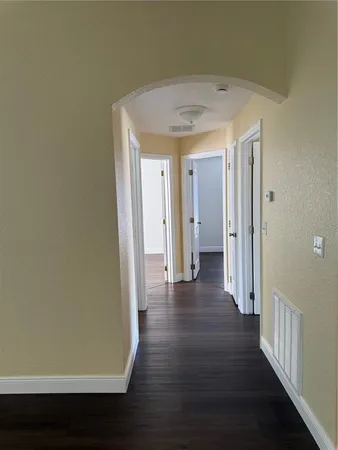 a view of a hallway with wooden floor