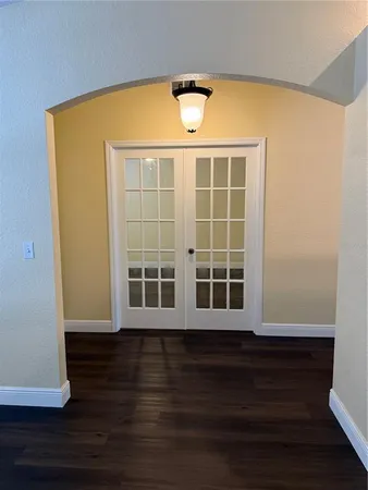 view of empty room with wooden floor and fan