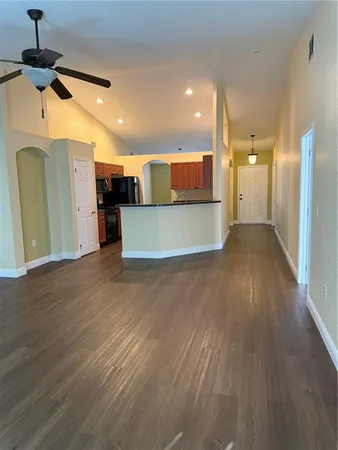 a view of a kitchen with a refrigerator and a window