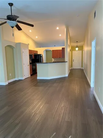 a view of a kitchen with a refrigerator and a window