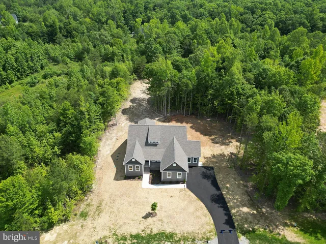 an aerial view of a house with yard swimming pool and outdoor seating