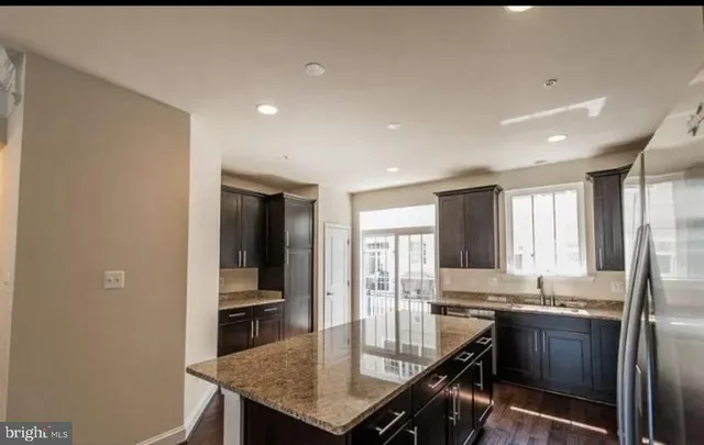a kitchen with granite countertop a sink and stove
