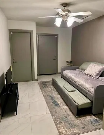 a bedroom with a large bed and a chandelier