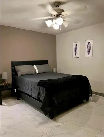 a bedroom with a bed window and a ceiling fan