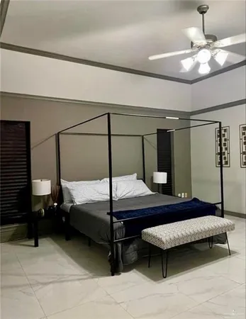 a bedroom with a bed a lamp and window