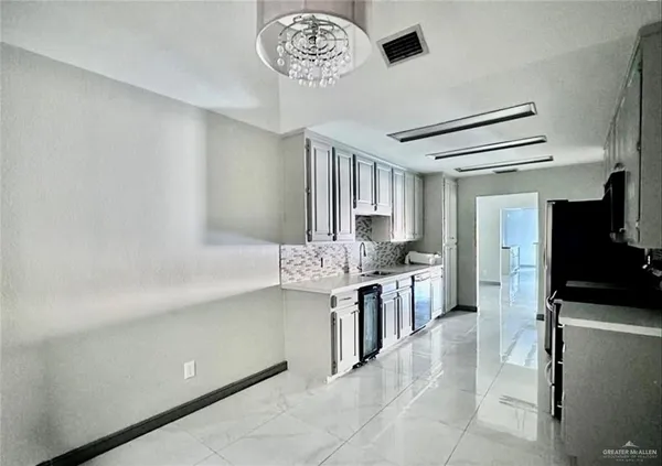 a kitchen with stainless steel appliances granite countertop a sink and a stove