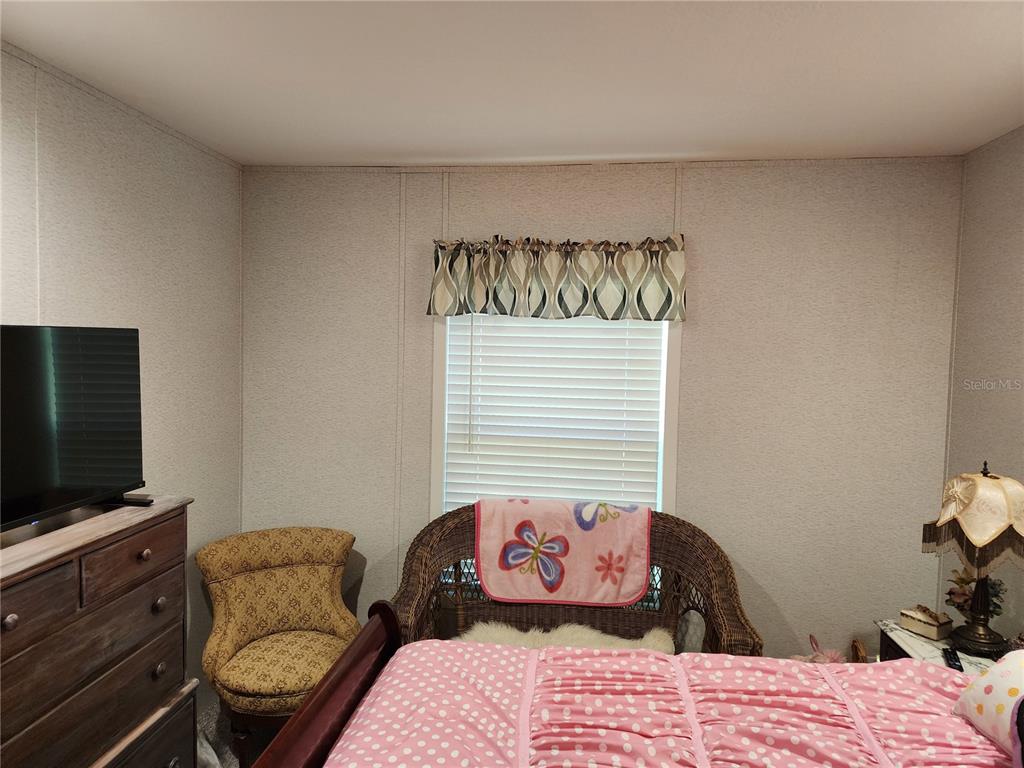 4150 South Spaniel Trail Inverness, FL 34450 - Photo 12 of 25 a bedroom with a bed and flat screen tv