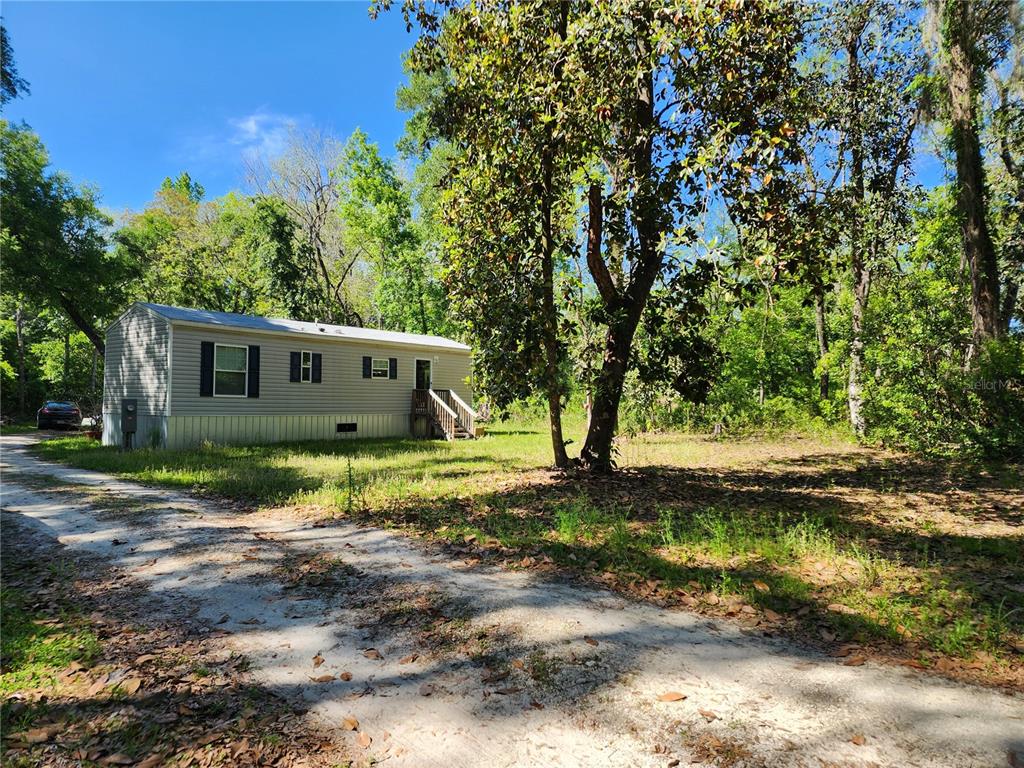 4150 South Spaniel Trail Inverness, FL 34450 - Photo 24 of 25 a view of a house with a yard