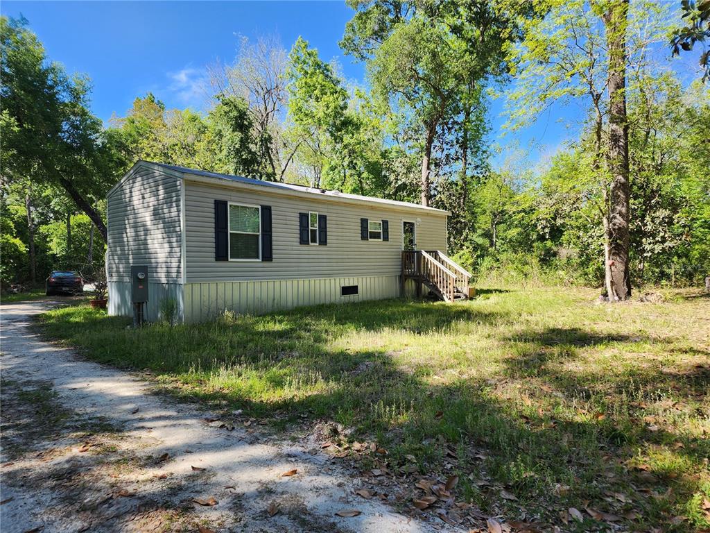 4150 South Spaniel Trail Inverness, FL 34450 - Photo 25 of 25 a view of a backyard with large trees