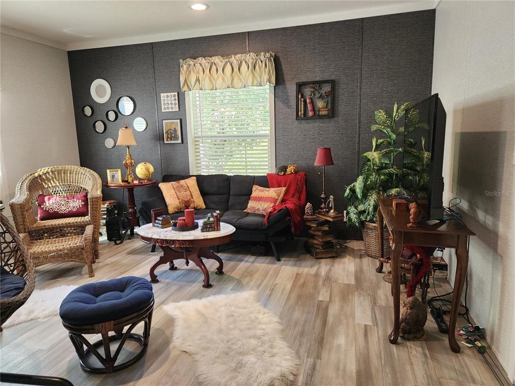 4150 South Spaniel Trail Inverness, FL 34450 - Photo 3 of 25 a living room with furniture a window and a flat screen tv