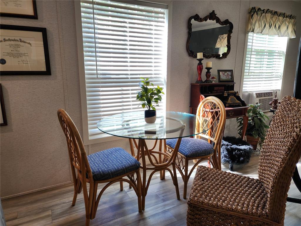 4150 South Spaniel Trail Inverness, FL 34450 - Photo 4 of 25 a view of a dining room with furniture window and wooden floor
