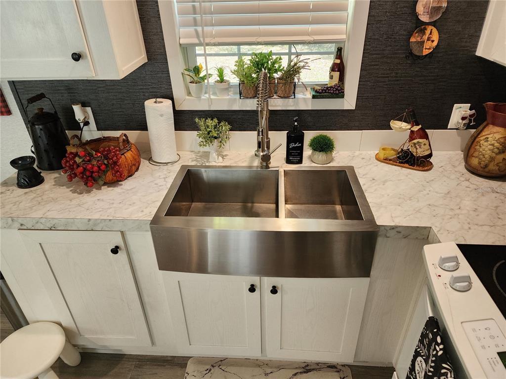 4150 South Spaniel Trail Inverness, FL 34450 - Photo 7 of 25 a kitchen with sink and white cabinets