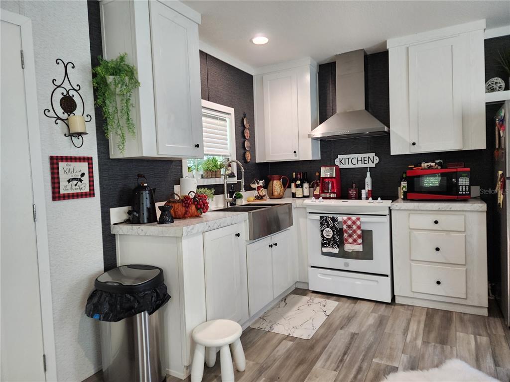 4150 South Spaniel Trail Inverness, FL 34450 - Photo 9 of 25 a kitchen with stainless steel appliances a refrigerator sink and cabinets