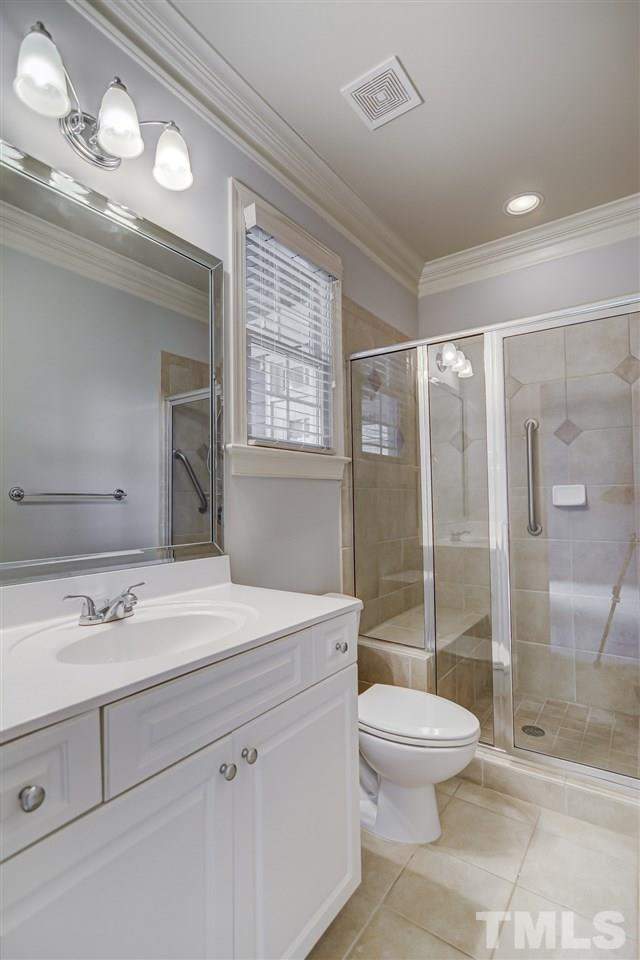 4213 Batiste Road Raleigh, NC 27613 - Photo 12 of 30 a bathroom with a sink a toilet and shower