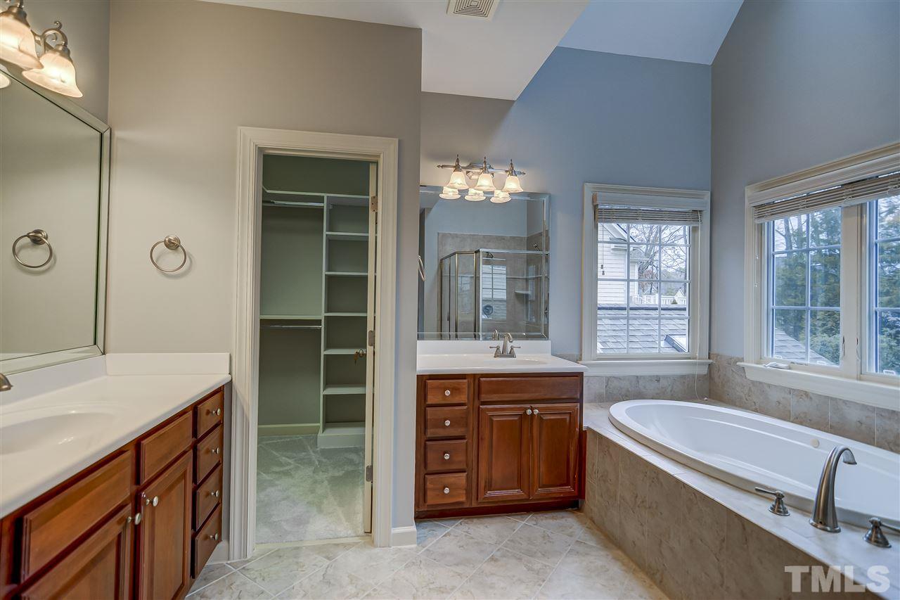 4213 Batiste Road Raleigh, NC 27613 - Photo 14 of 30 a bathroom with a granite countertop tub sink and mirror