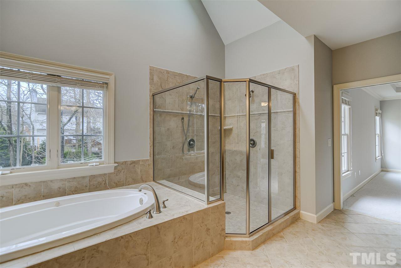 4213 Batiste Road Raleigh, NC 27613 - Photo 15 of 30 a bathroom with a large tub a shower and view