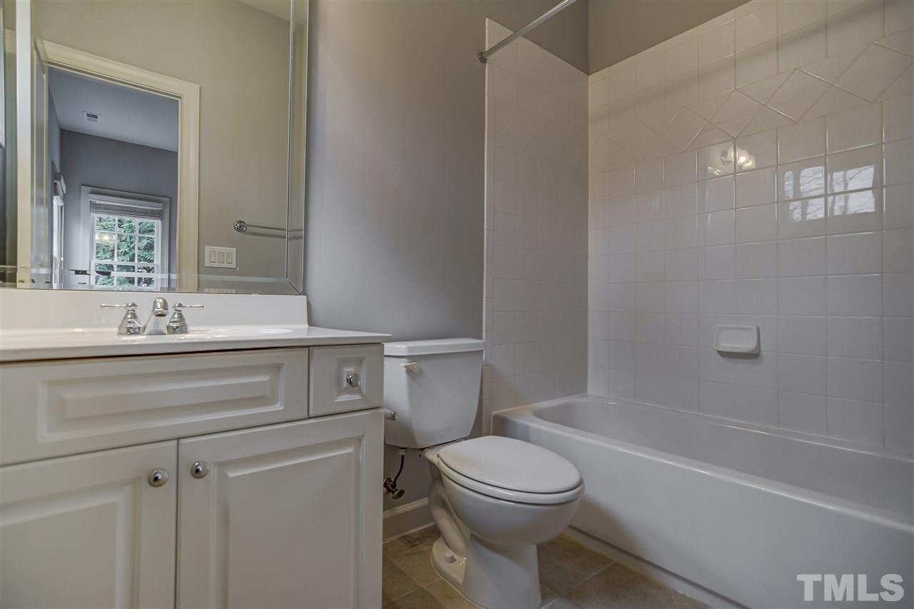 4213 Batiste Road Raleigh, NC 27613 - Photo 17 of 30 a bathroom with a sink a toilet and shower