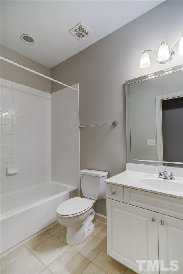 4213 Batiste Road Raleigh, NC 27613 - Photo 21 of 30 a bathroom with a sink a toilet a mirror and shower
