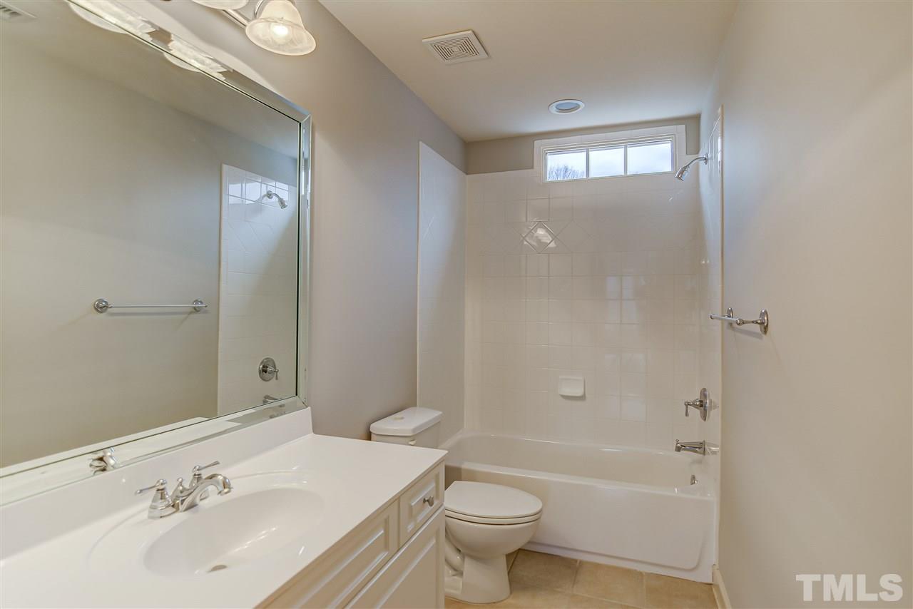 4213 Batiste Road Raleigh, NC 27613 - Photo 27 of 30 a bathroom with a sink a toilet and shower