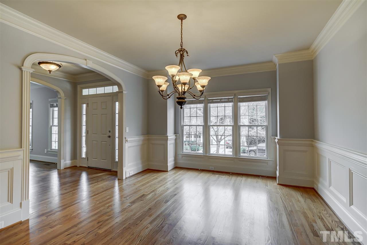 4213 Batiste Road Raleigh, NC 27613 - Photo 4 of 30 a view of an empty room with wooden floor and a window