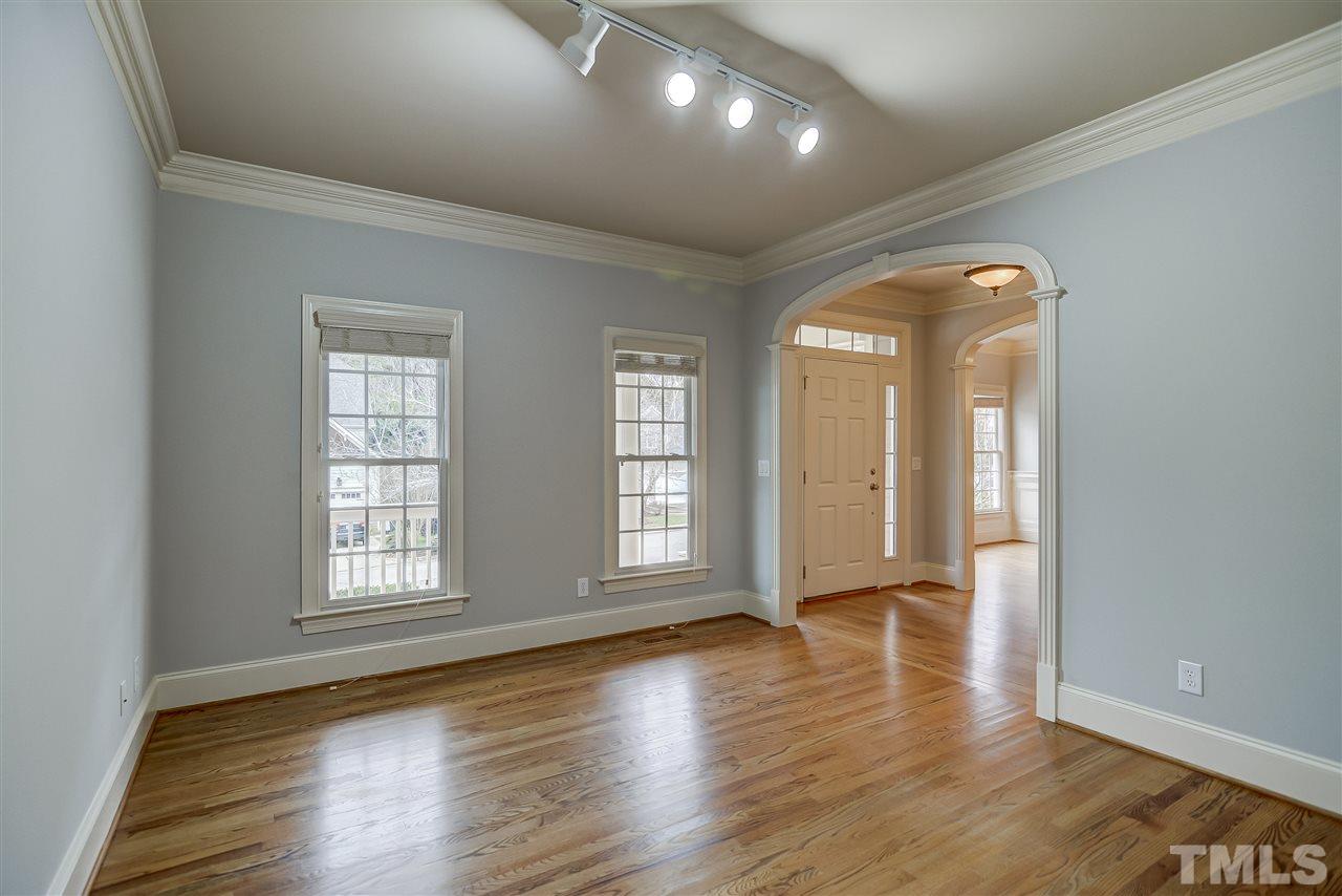 4213 Batiste Road Raleigh, NC 27613 - Photo 5 of 30 an empty room with wooden floor and windows
