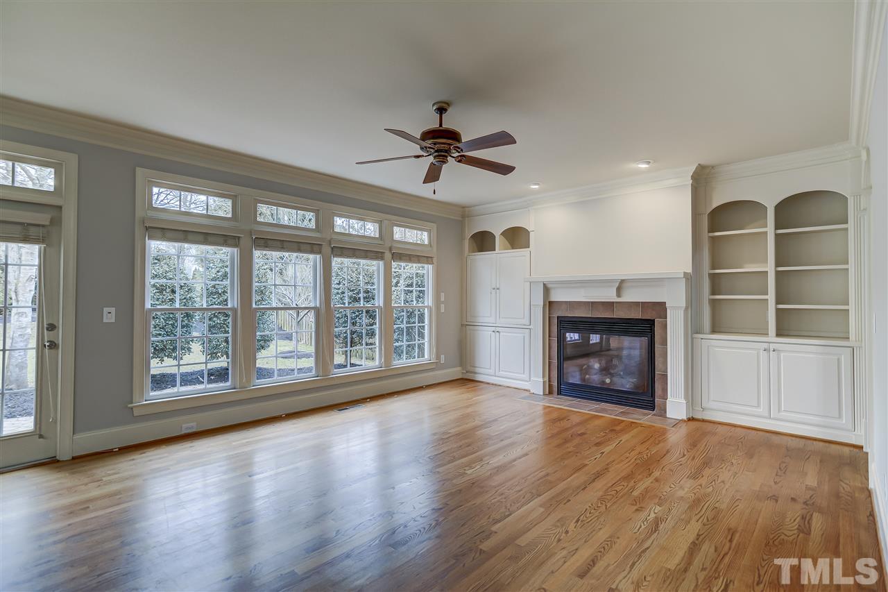 4213 Batiste Road Raleigh, NC 27613 - Photo 6 of 30 a view of an empty room with a window and wooden floor