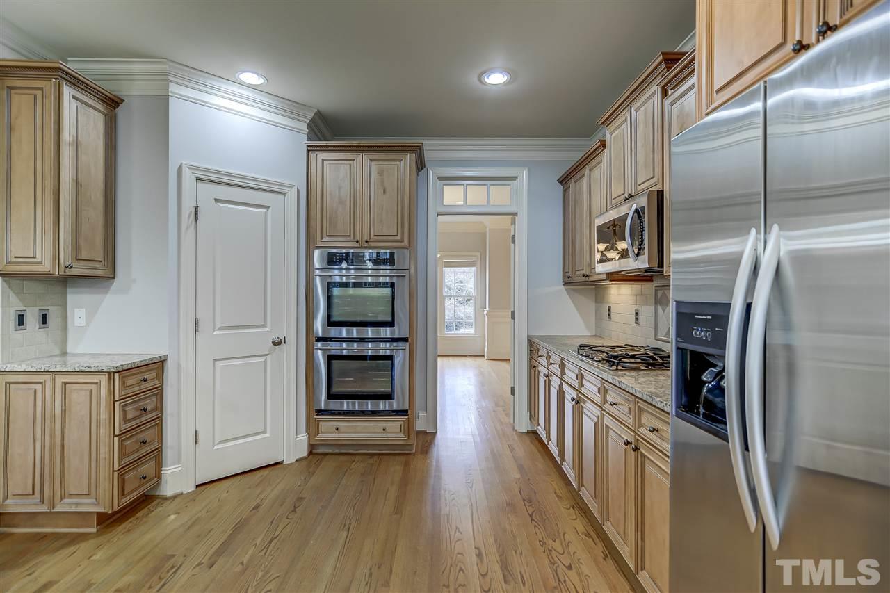 4213 Batiste Road Raleigh, NC 27613 - Photo 8 of 30 a kitchen with stainless steel appliances granite countertop a refrigerator and a stove top oven