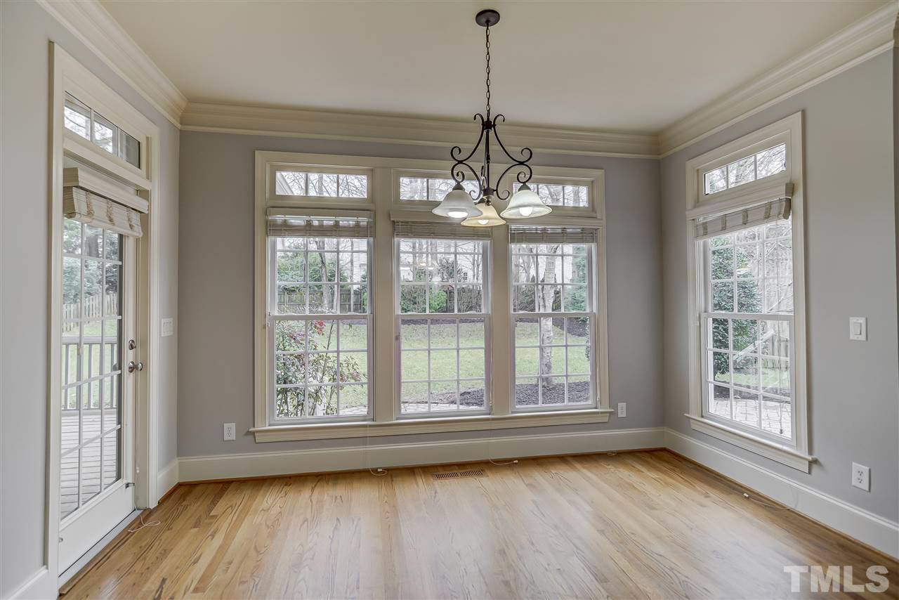 4213 Batiste Road Raleigh, NC 27613 - Photo 10 of 30 a view of an empty room with wooden floor and a window