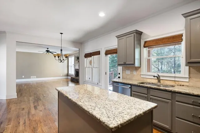 a kitchen with granite countertop sink stove and refrigerator