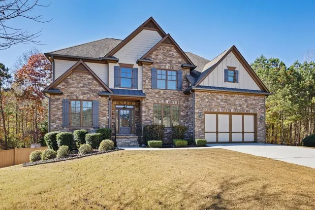 a front view of a house with a yard and garage