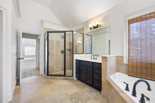 a bathroom with a bathtub sink and mirror