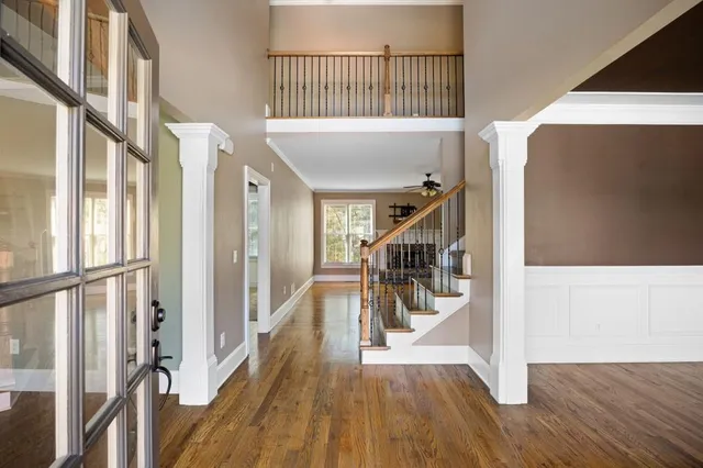 a view of entryway and hall with wooden floor