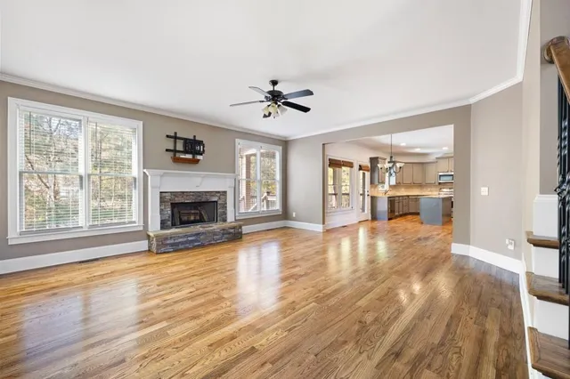 a view of empty room with wooden floor and fireplace