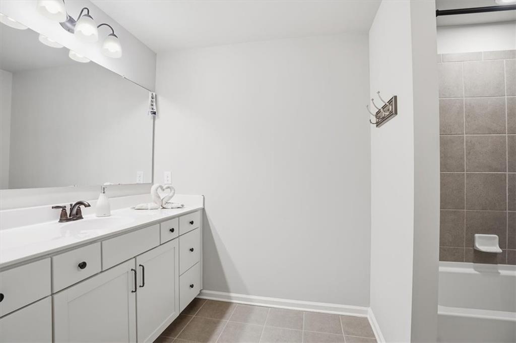 6265 Privet Way Cumming, GA 30028 - Photo 24 of 47 a bathroom with a double vanity sink and mirror