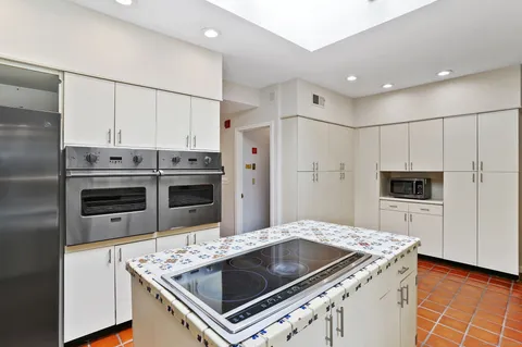 a kitchen with a stove and a refrigerator