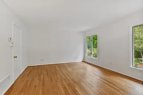 a view of a room with wooden floor and window