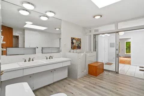 a spacious bathroom with a double vanity sink and a mirror
