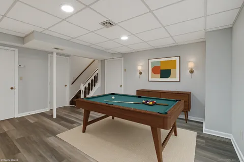 a living room with furniture a table and wooden floor