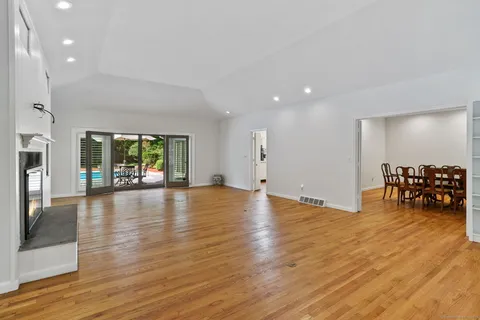 a view of a room with furniture and a wooden floor
