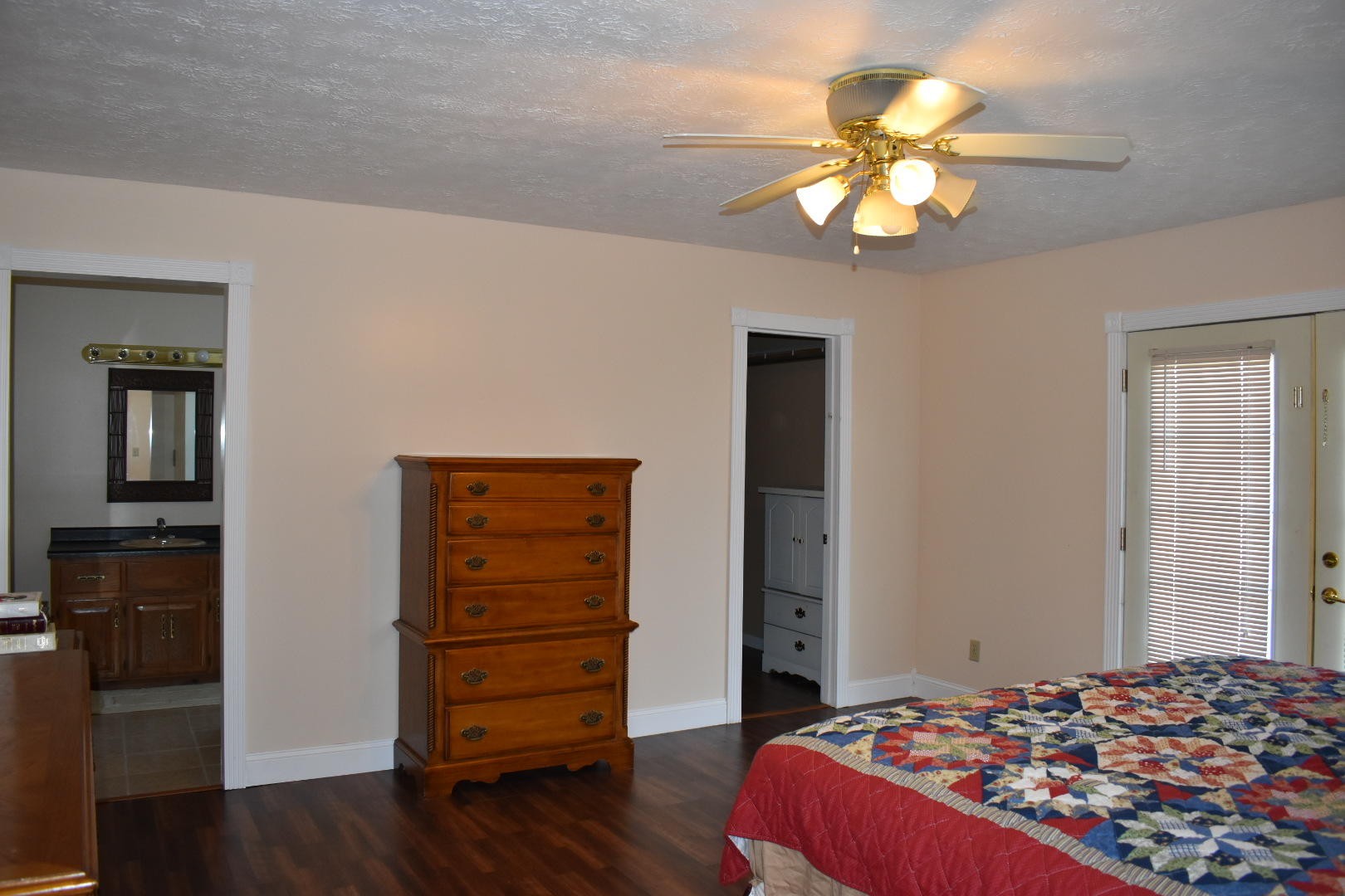 1513 Leatherwood Road Oneida, TN 37841 - Photo 15 of 37 a bedroom with a bed and a chandelier