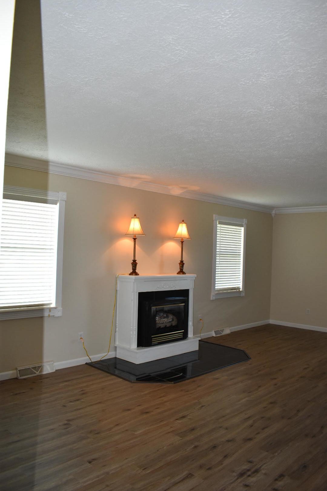 1513 Leatherwood Road Oneida, TN 37841 - Photo 25 of 37 a living room with furniture a fireplace and a wooden floor