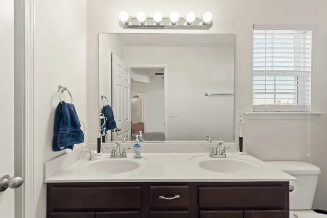 a bathroom with a sink vanity and a mirror
