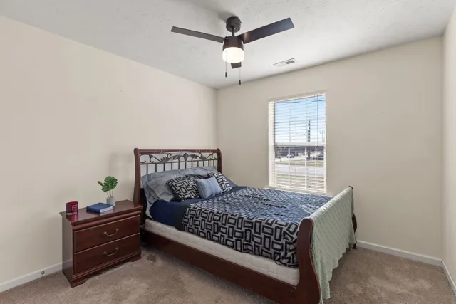 a bed room with a bed and a window