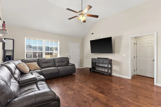 a living room with furniture and a flat screen tv
